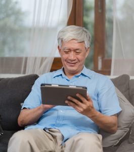 old man ordering food from his room using a tablet